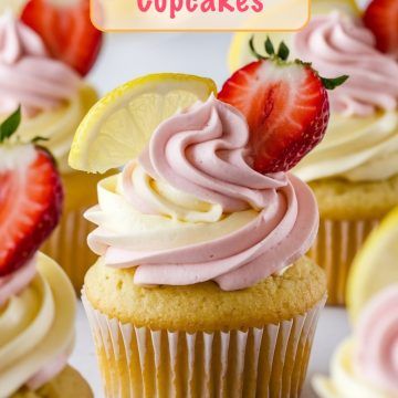 cupcakes with pink frosting and strawberries on top, surrounded by lemon slices