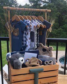 a wooden crate filled with clothing and stuffed animals