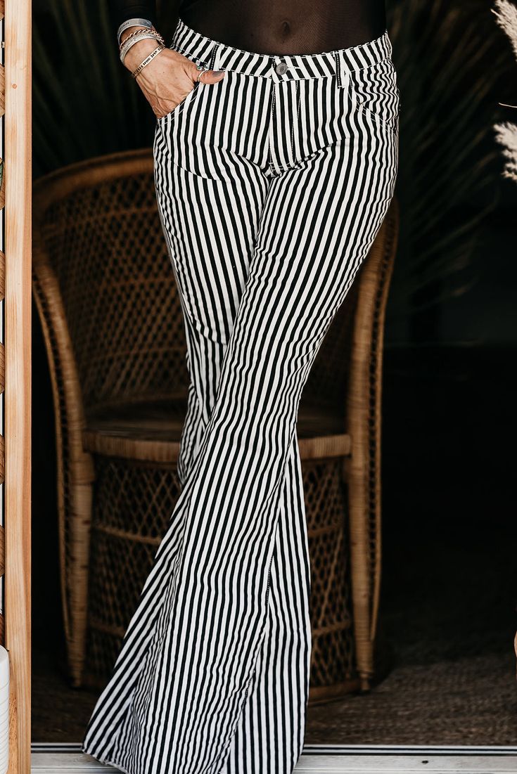 Our Pinstripe Flares are giving us all the 70's vibes with the ultra wide bell bottom and high waist. The thin black and white stripes on these bad boys are actually very flattering and elongate the leg. Throw on our Wild & Free Tee for the perfect updated 70's look. Premium Denim Button and Zipper Fly High Waist Ultra Flared Length: 45” Rise 11” Model is Wearing a Small 70s Look, Ultra Wide, Wild Free, Black And White Stripes, Pants Large, Fly High, Bell Bottom, Summer 2022, Premium Denim