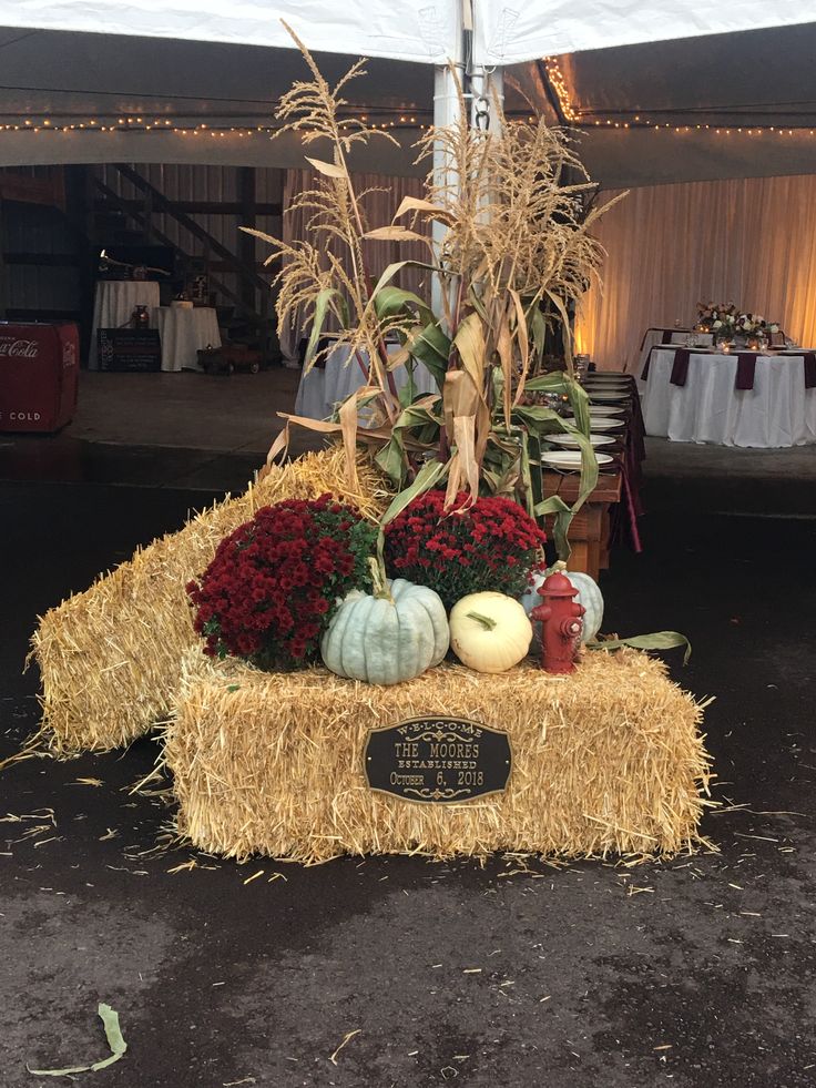 a hay bale filled with flowers and pumpkins