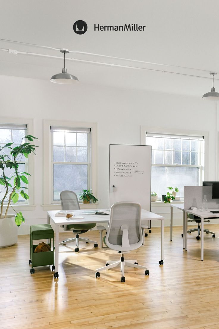 an office with white walls and wooden floors