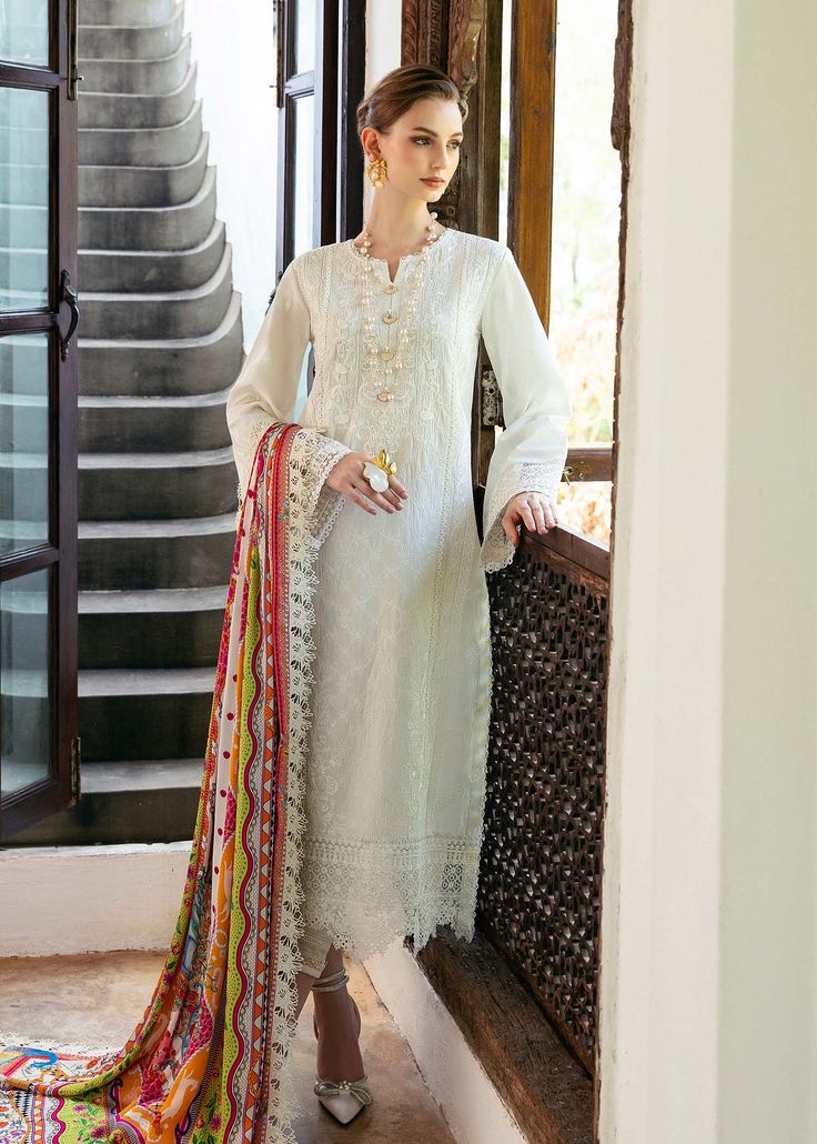 Brand: Kanwal MalikCollection: Mayal by Kanwal Malik Unstitched Luxury Lawn CollectionFabric: Lawn DESCRIPTION: Drenched in the ethereal hues of anglic white canvas get ready to be enchanted by the delicate embroidery that weaves an intricate delicate motif adorned with graceful florals and dainty patterns. Luxurious schiffli border elevate this masterpiece, turning it into a breathtaking manifestation of heritage and elegance. As your eyes wander, a luscious, pure silk dupatta unfolds, showcasing an artistry of blooming flowers, playful festoons, and vivid hues. Encased within a geometric border, it exudes a vibrant festivity that enlivens the entire composition. DESIGN DETAILS: Embroidered Shirt Front Center Panel (Lawn) – 1Pcs Embroidered Front Right Panel (Lawn) – 1Pcs Embroidered Fron Lengha Modern, Pakistani Dresses Online Shopping, Latest Kurtis, Chiffon Suit, Organza Suits, Pakistani Dresses Online, Indian Salwar Kameez, Desi Outfits, Pakistani Fashion Party Wear