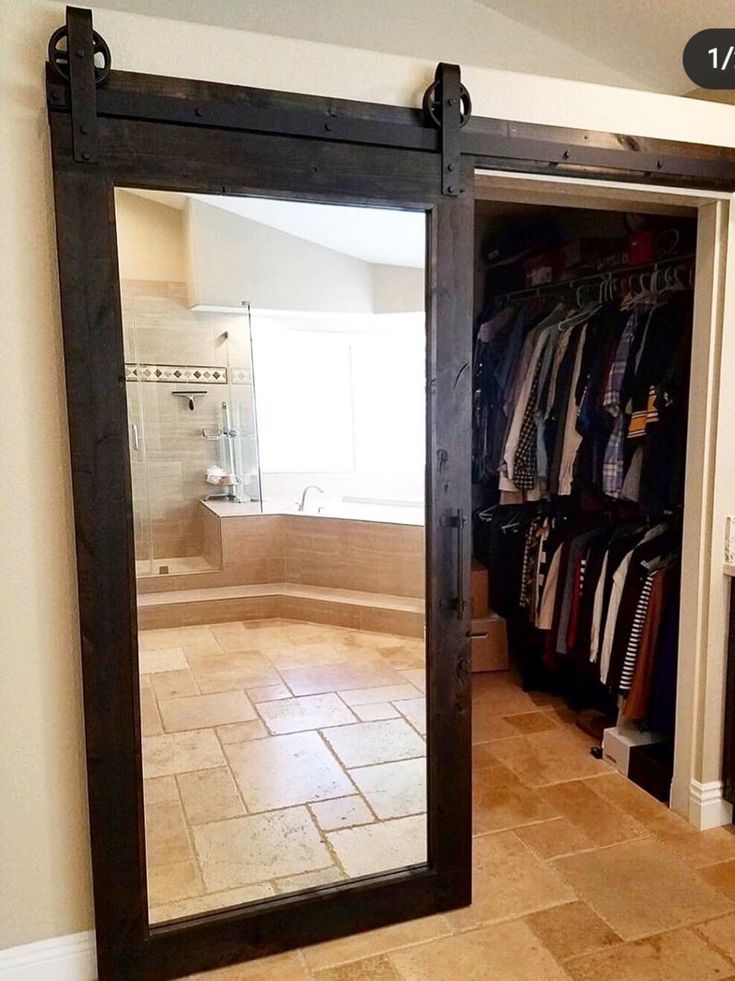 a mirror that is in the middle of a room next to a sink and closet