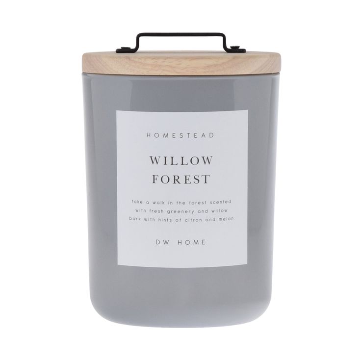 a candle that is sitting on top of a white surface with the words willow forest in front of it