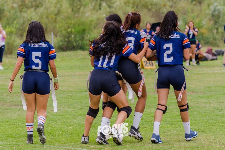 a group of women playing soccer on a field