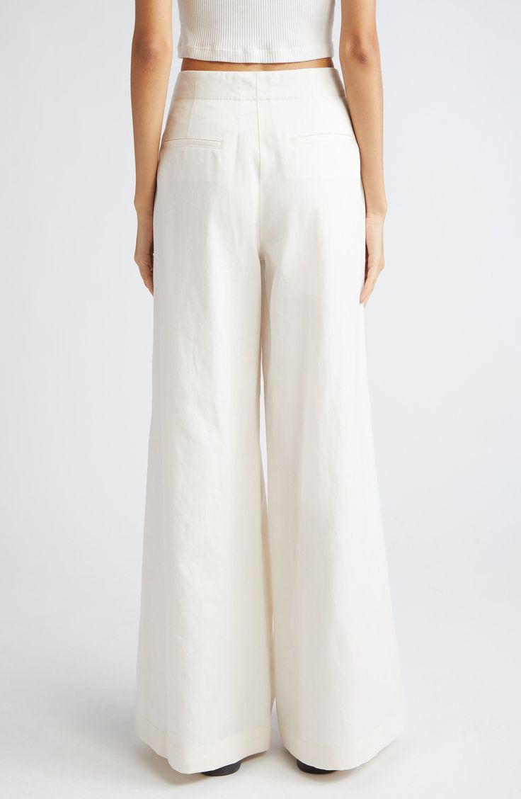 Dramatically flared wide legs lend runway-worthy movement to ultrahigh-waist pants softly kissed with fresh linen and cotton fibers. 32 1/2" inseam; 32" leg opening; 12" front rise; 15 1/2" back rise (size 8) Zip fly with hook-and-bar closure Front slant pockets 44% linen, 29% cotton, 27% lyocell Dry clean Made in the USA Elegant Wide Leg Cotton Pants, Chic Cream Wide Leg Full-length Pants, Chic Cream Full Length Wide Leg Pants, Full Length Cotton Wide Leg Pants, Chic High-waisted Flares For Summer, High Waist Cotton Flares For Summer, White Flare Wide Leg Pants For Work, Summer High Waist Cotton Flares, Summer High-waist Cotton Flares