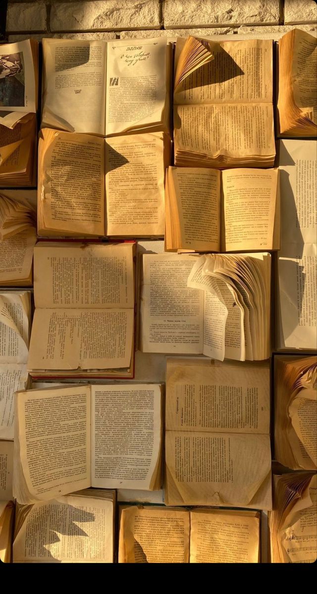 many open books are stacked on top of each other in the shape of a wall