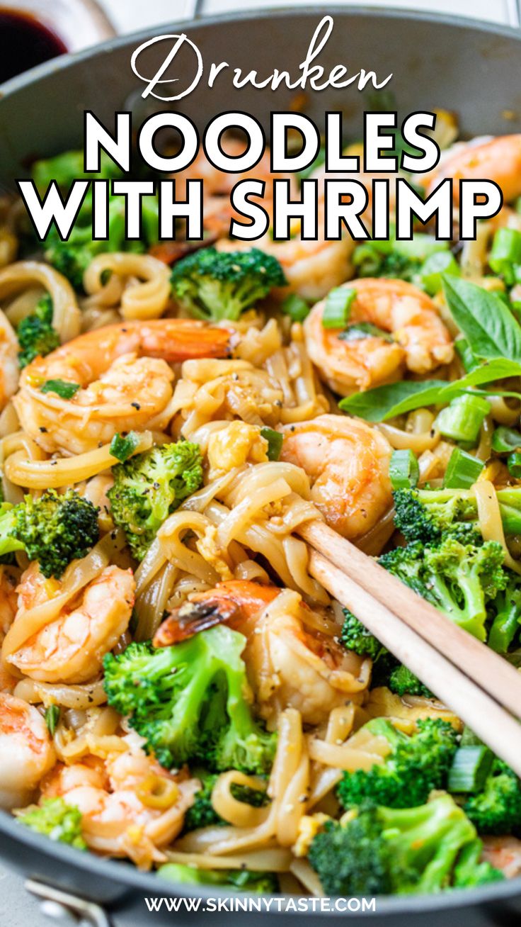 shrimp, broccoli and noodles in a skillet with chopsticks on the side