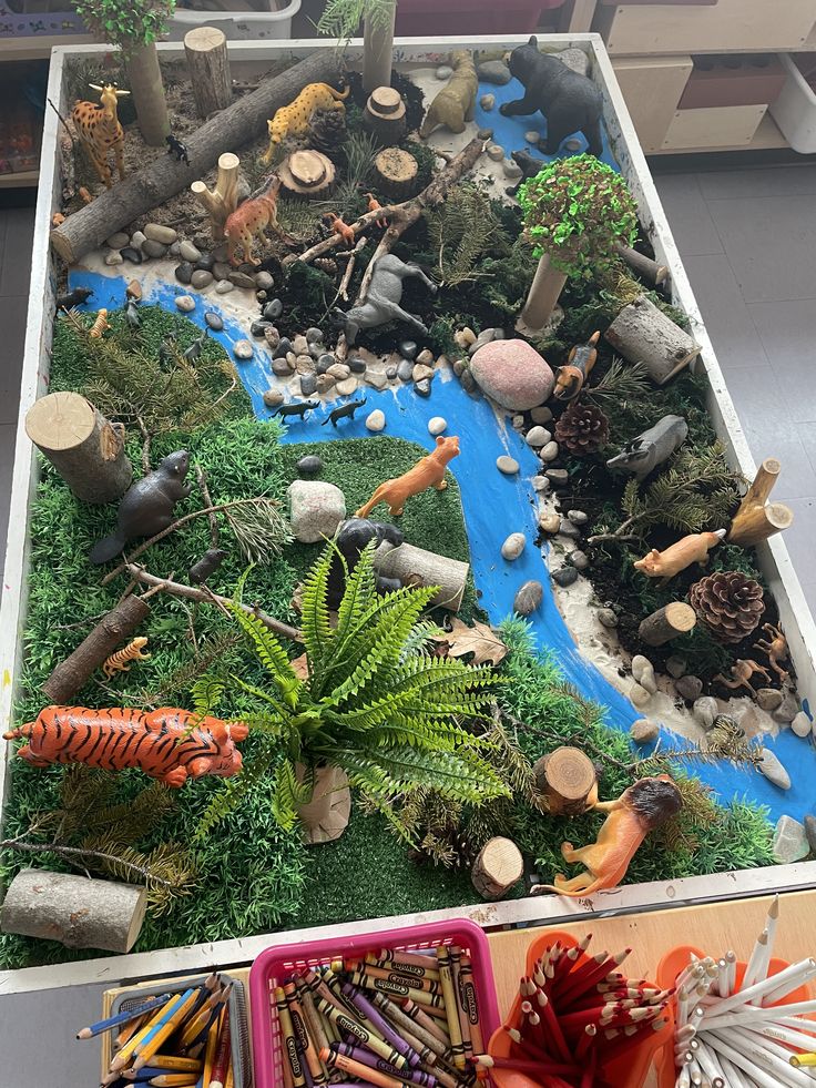 a table topped with lots of different types of plants and animals on top of it