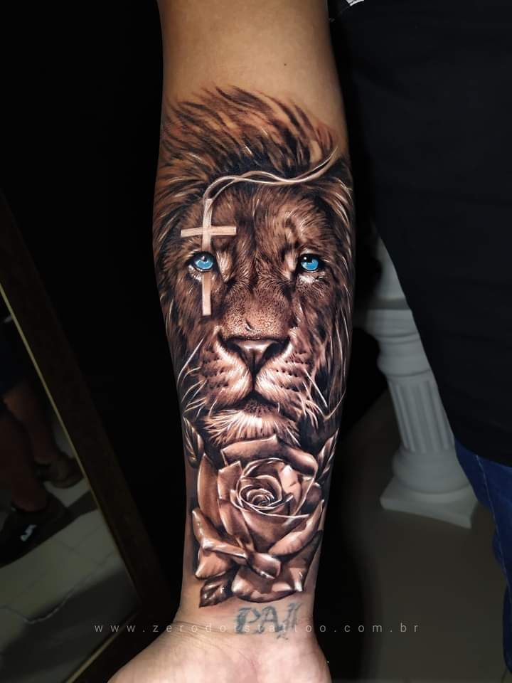 a man's arm with a lion and cross on it