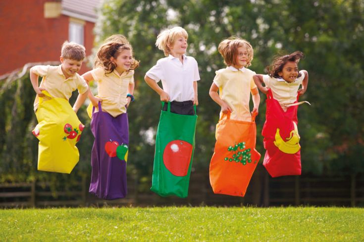 five children jumping in the air with colorful clothing on