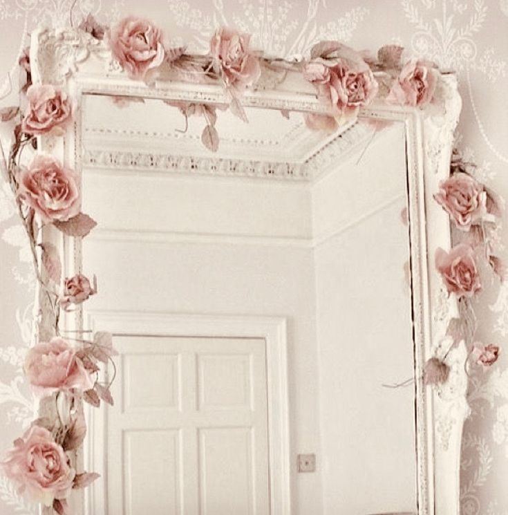 there is a mirror with pink flowers on it