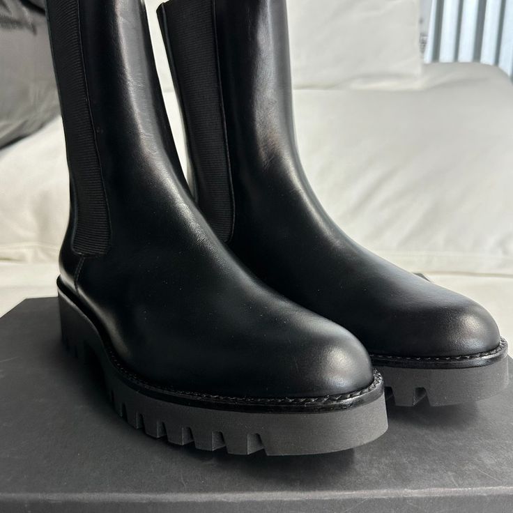 Size 9 Black Chelsea Boots With Lug Sole For Formal Occasions, Black Leather Chelsea Boots With Lug Sole, Black Chelsea Boots With Lug Sole In Calf Leather, Black Leather Chelsea Boots With Flat Heel, Black Calf Leather Chelsea Boots With Lug Sole, Calf Leather Chelsea Boots With Textured Sole, Black Leather Chelsea Boots With Textured Sole, Black Boots With Lug Sole, Elegant Black Boots With Vibram Sole