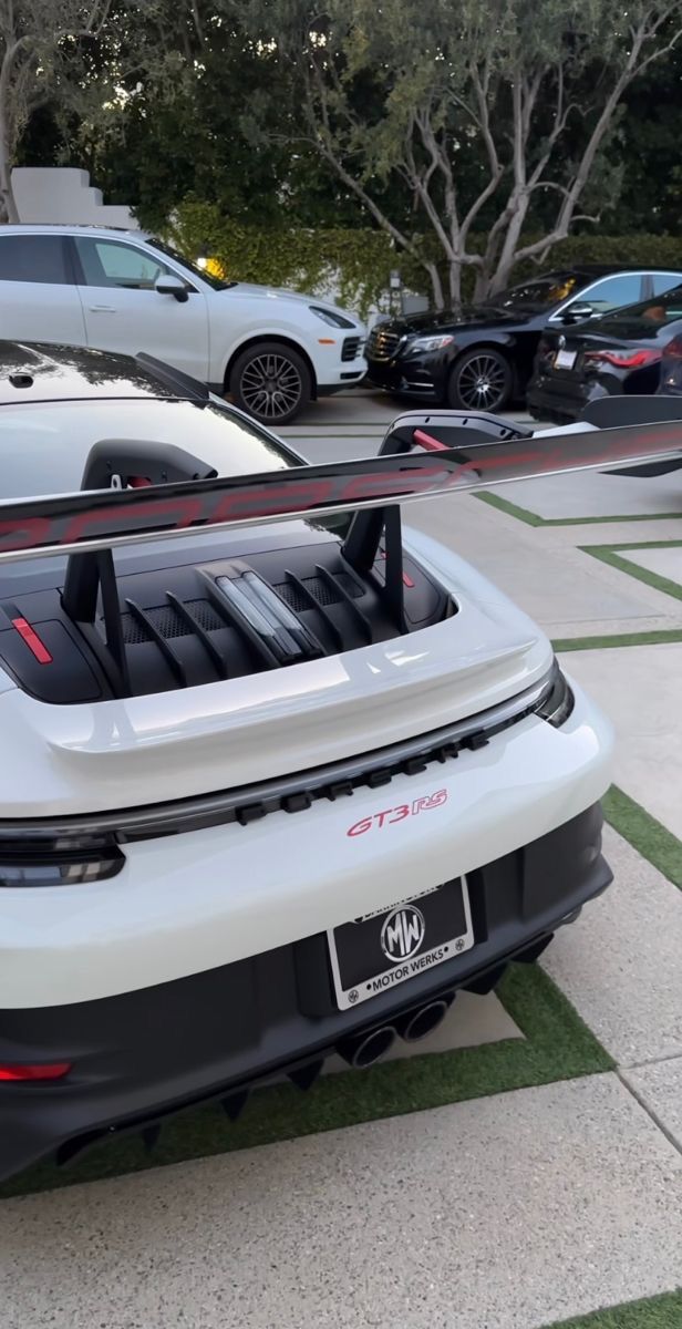 a white sports car parked in a parking lot