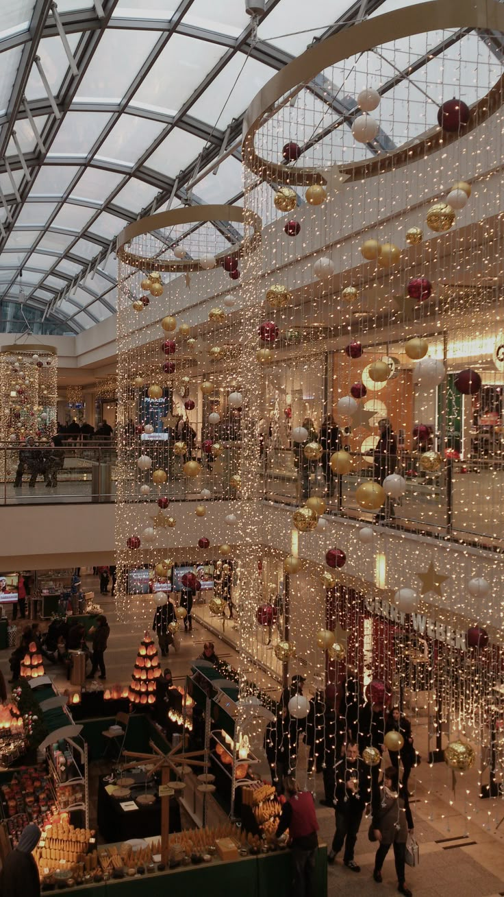 an indoor shopping mall filled with lots of christmas decorations