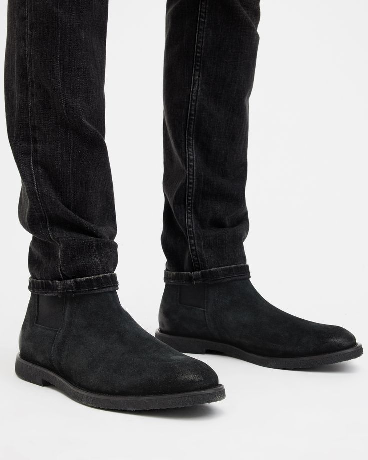 For casual occasions, step out in the Rhett Boots, crafted from soft suede and finished with a crepe rubber outsole. Shaped to a traditional Chelsea boot shape.  These boots fit true to size Round toe Ankle boot Pull tab Chelsea boots Elasticated gusset AllSaints 01-11-94 stamp Casual Suede Moc Toe Boots, Casual Suede Boots With Suede Lining, Casual Leather Chelsea Boots With Vibram Sole, Suede Moc Toe Boots With Leather Footbed, Suede Boots With Vibram Sole And Moc Toe, Suede Ankle Boots With Vibram Sole, Casual Chelsea Boots With Vibram Sole, Fall Suede Boots With Contrast Sole, High-top Suede Chelsea Boots With Leather Sole