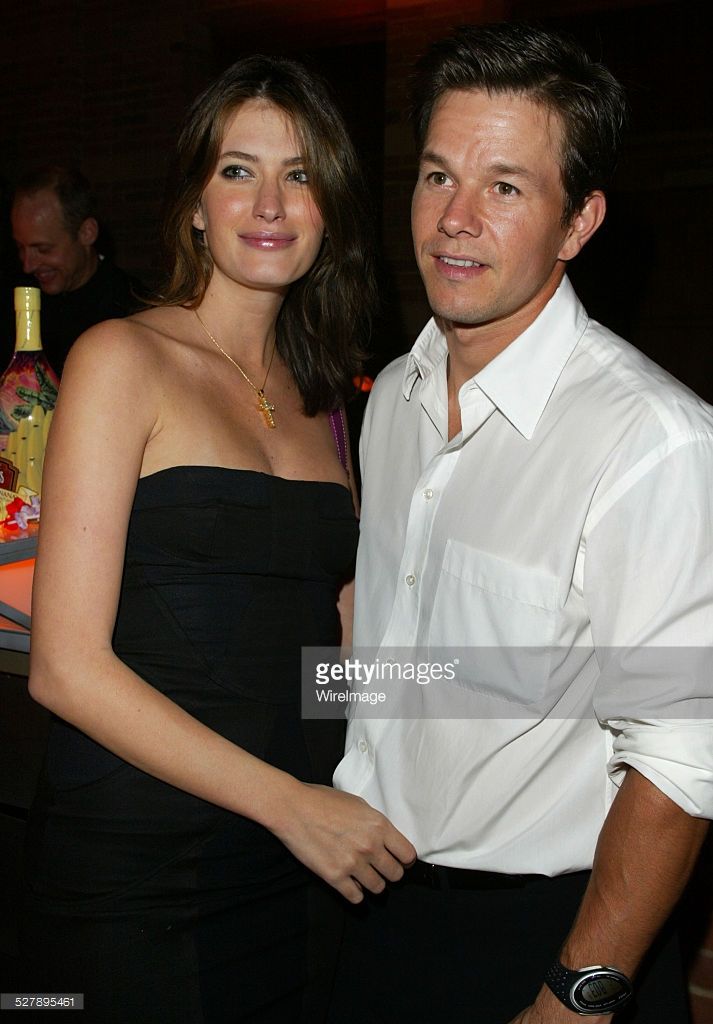 a man and woman standing next to each other in front of a table with drinks on it