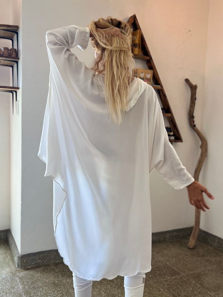 Gorgeous free-flow loose rayon/cotton top for intentional gatherings and practices 🤍 This oversized shirt can be worn as a Ceremony or Kundalini white piece as well as a part of a nomadic festival outfit. Designed by our Moroccan friends from LA this piece truly resembles the nomad lifestyle. We fell in love with its comfy feel and are honored to add it to our “Ceremony White” collection of pieces created with intention to support you on your journeys Within and connecting to the Higher Self. T Flowy White Top For Beach Cover-up, Bohemian Long Sleeve Loungewear Blouse, Oversized Long Sleeve Tunic For Beach Cover-up, Casual White Long Sleeve Kaftan, Oversized Lagenlook Tunic For Loungewear, Relaxed Fit Lagenlook Blouse For Beach, Bohemian Relaxed Fit Blouse For Loungewear, White Tunic Blouse For Festival, Bohemian White Tunic For Loungewear