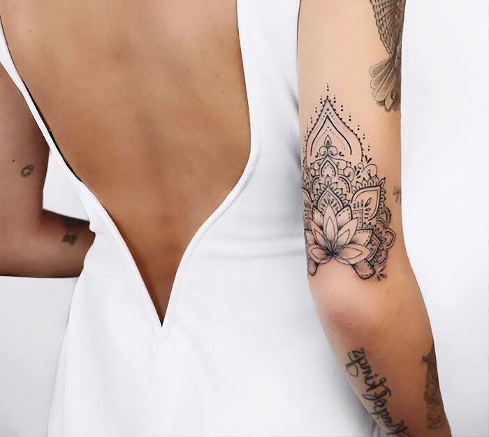 a woman with a tattoo on her arm