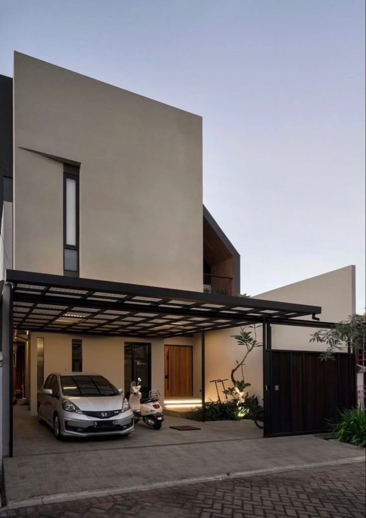 a car is parked in front of a house with an awning on the roof