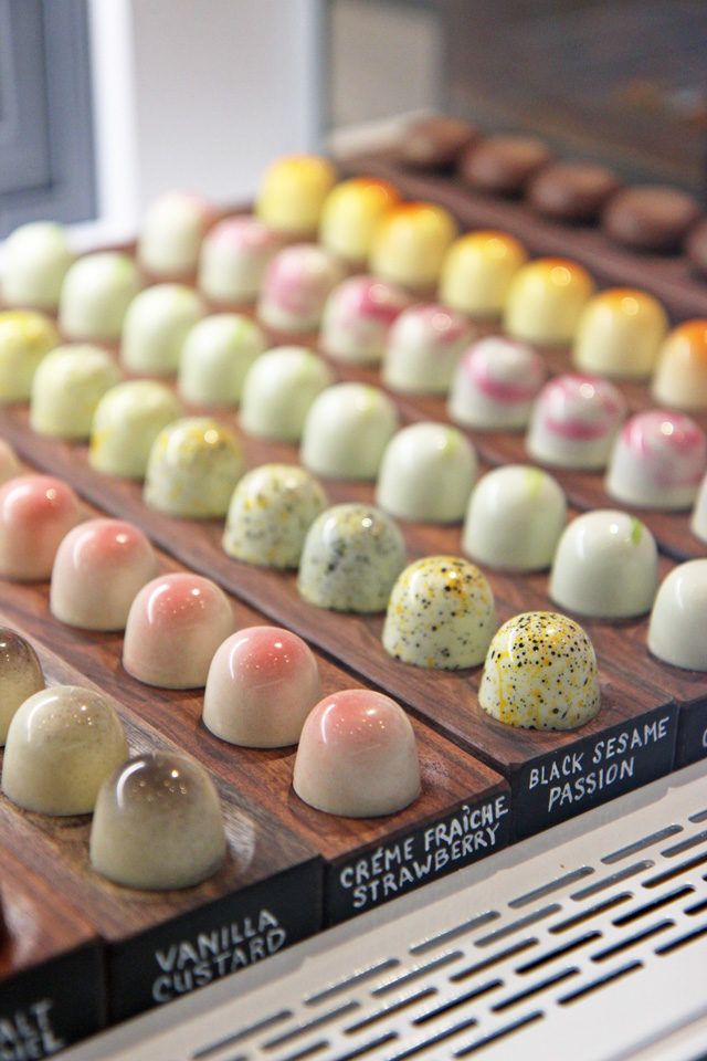 there are many different types of chocolates on the display shelf in front of each other