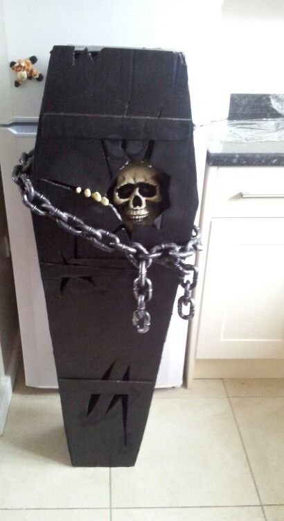 a black box with chains and a skull on it's side in a kitchen