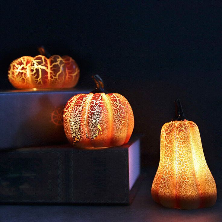 three lit pumpkins sitting next to each other