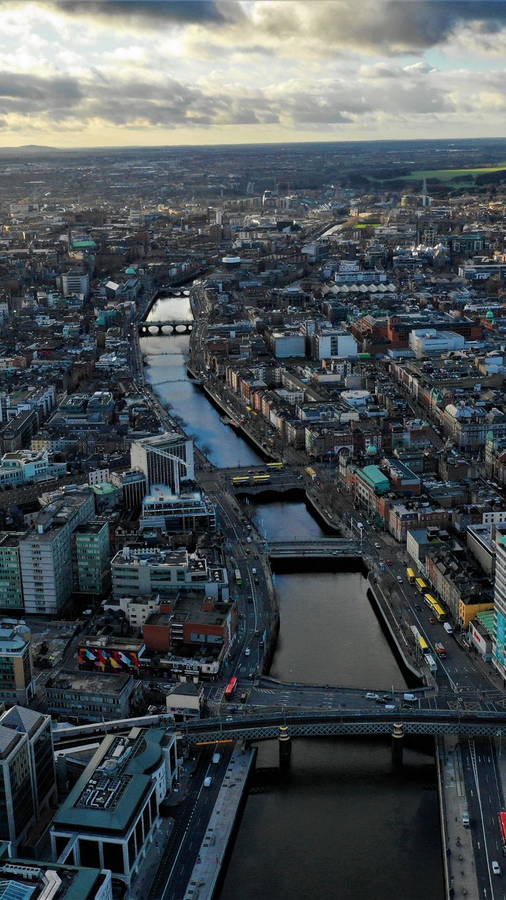 an aerial view of a city with bridges and river running through it's center