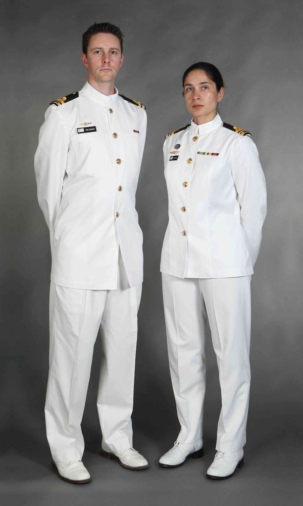 two people in white uniforms standing next to each other with their hands on their hipss