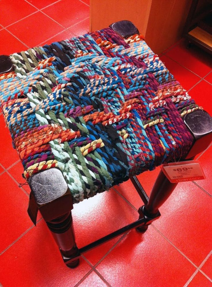 a multicolored bench on a red tiled floor