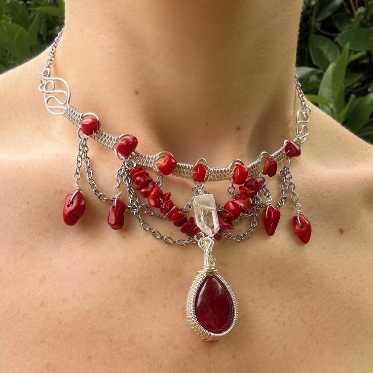 This handmade necklace is wire wrapped with silver plated wire, featuring a Quartz point and Bamboo Coral chips. The necklace also features chains and a wire wrapped Red Agate pendant. All orders include freebie crystals and stickers. Bamboo Coral, Wrap Jewelry, Wire Wrapped Necklace, Red Agate, Agate Pendant, Quartz Necklace, Quartz Points, Handmade Necklace, Red Coral