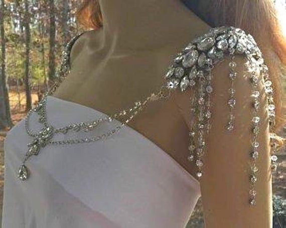 the back of a woman's dress with beading on it