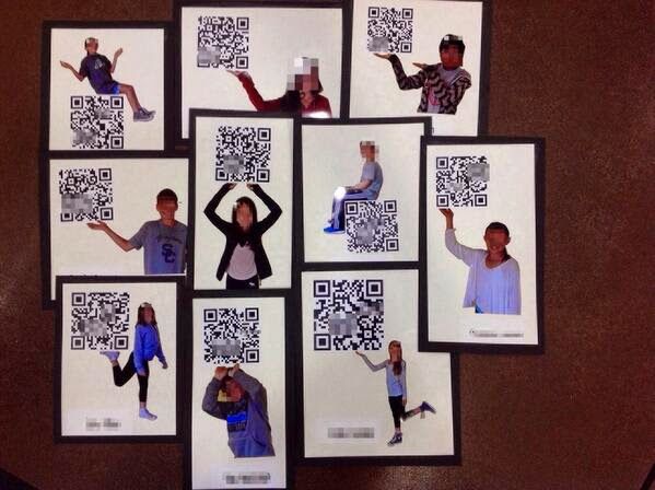 a group of people standing next to each other with qr code pictures on them