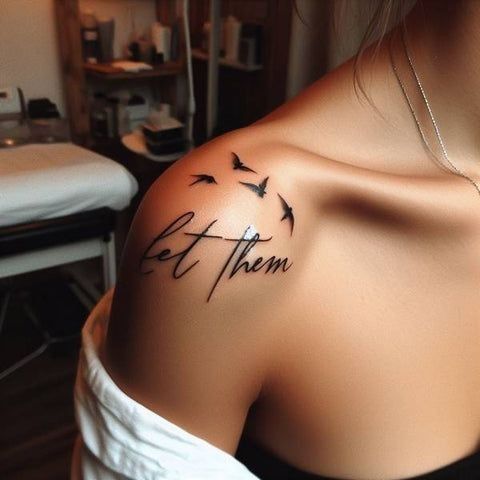 a woman with a tattoo on her shoulder that says let them fly