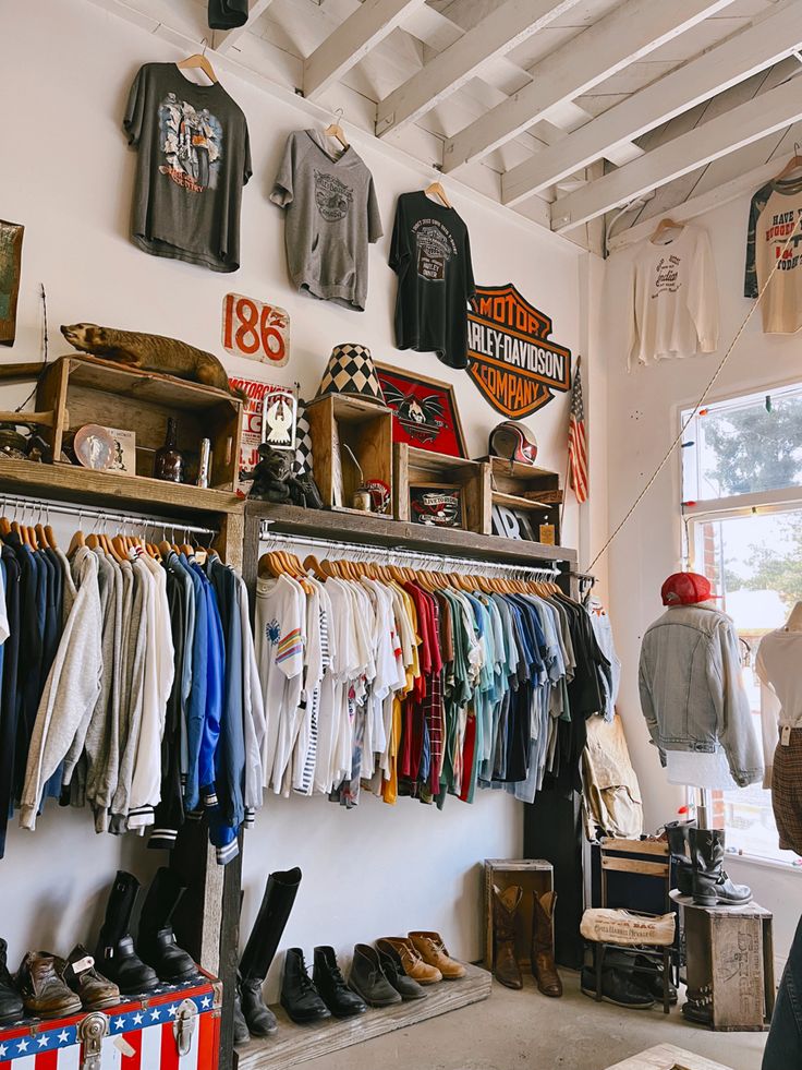 a room filled with lots of different types of shirts and shoes hanging on the wall