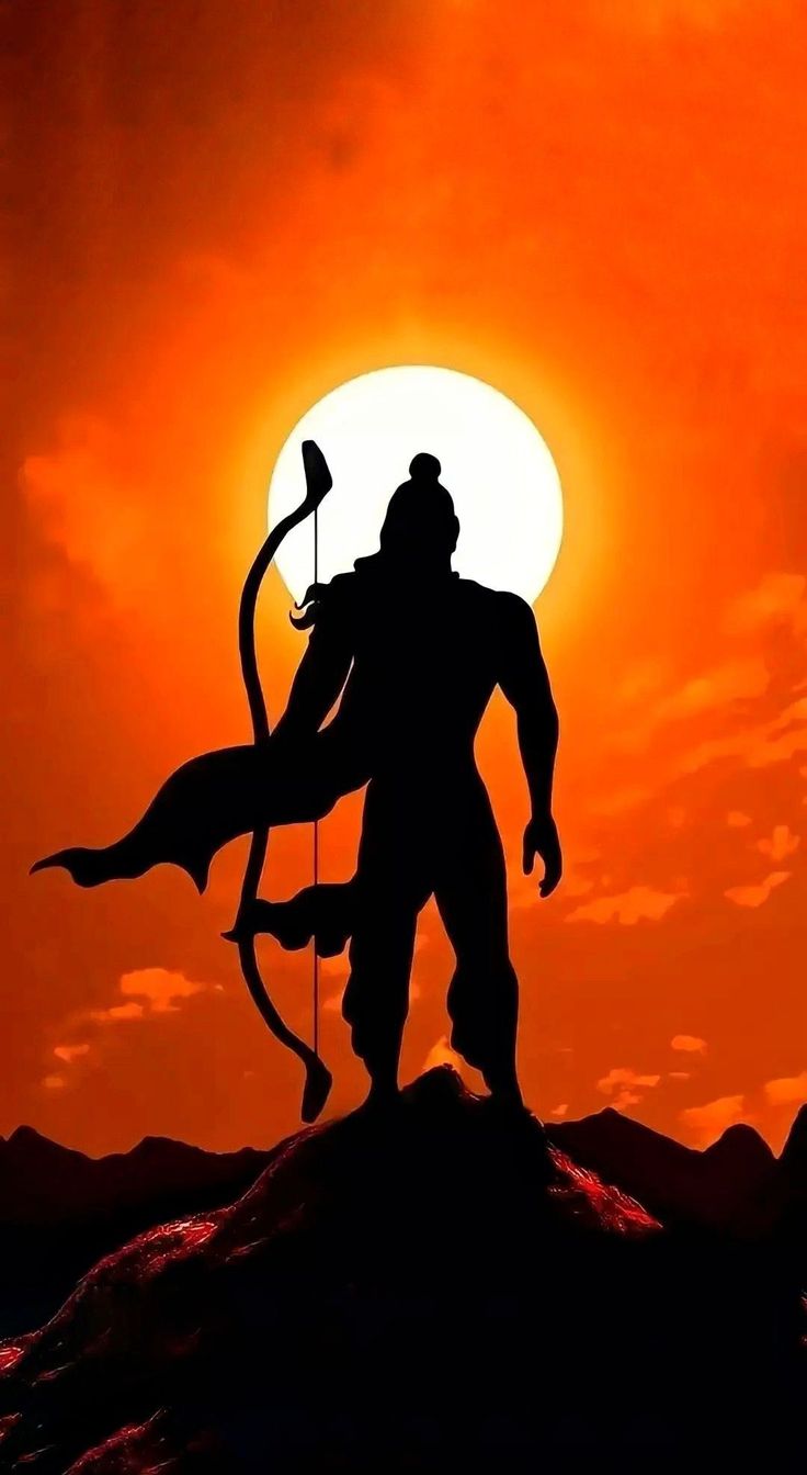 the silhouette of a man holding an arrow and standing on top of a hill at sunset