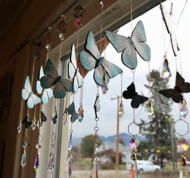 several butterflies hanging from the side of a window