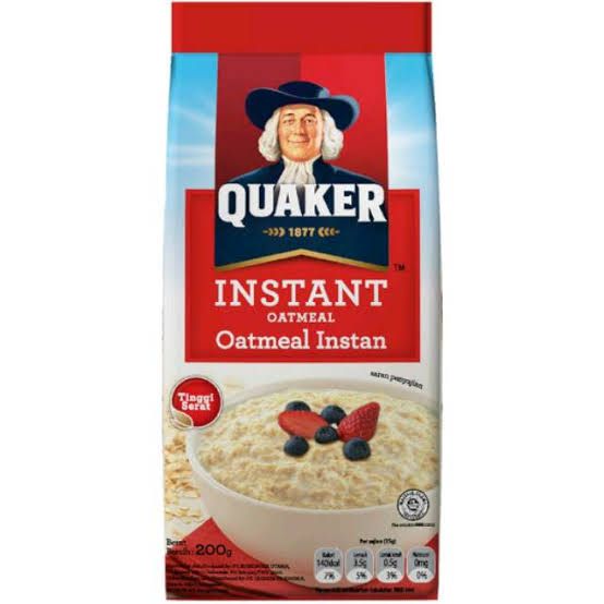 an oatmeal with berries in it is on the white background and red packaging