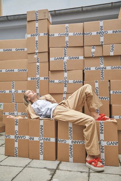 a man laying on top of cardboard boxes