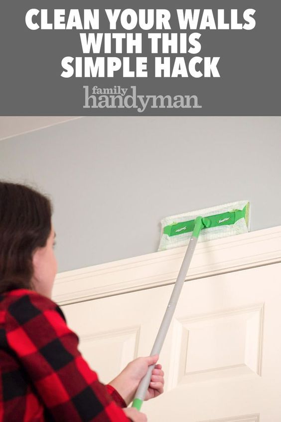 a woman with a mop in her hand is cleaning the door