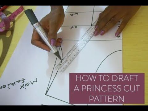 someone cutting out a princess's cut pattern on paper with scissors and rulers