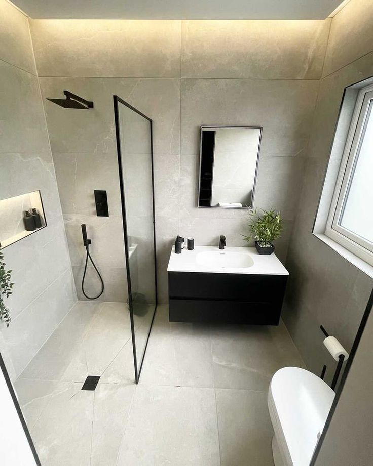 a bathroom with a toilet, sink and shower