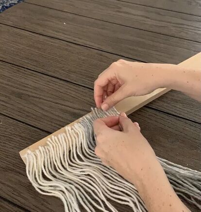 a person that is making something out of some kind of material on a table top