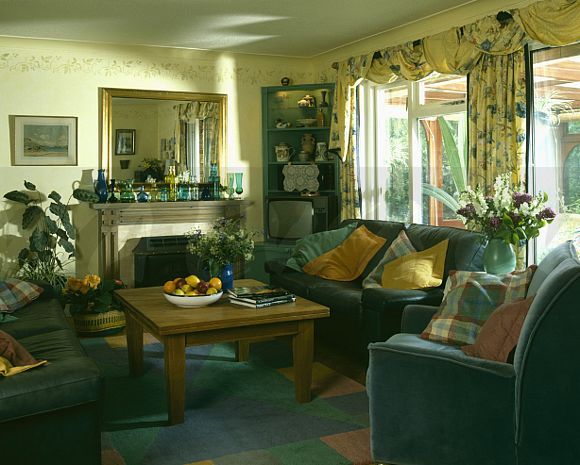 a living room with couches, chairs and a table in front of a fire place