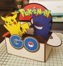 a box that has some paper cut outs in it with pikachu and go