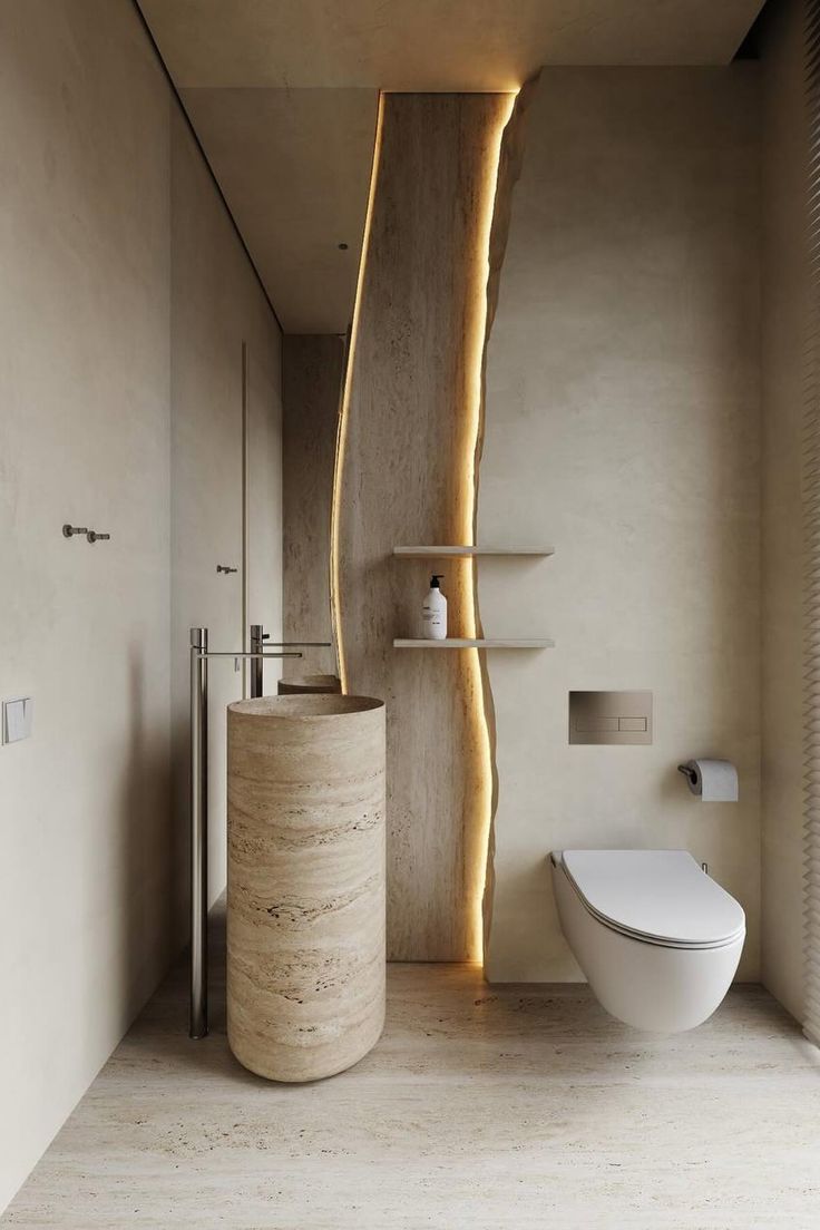 a bathroom with a toilet, sink and shelves in the wall next to each other