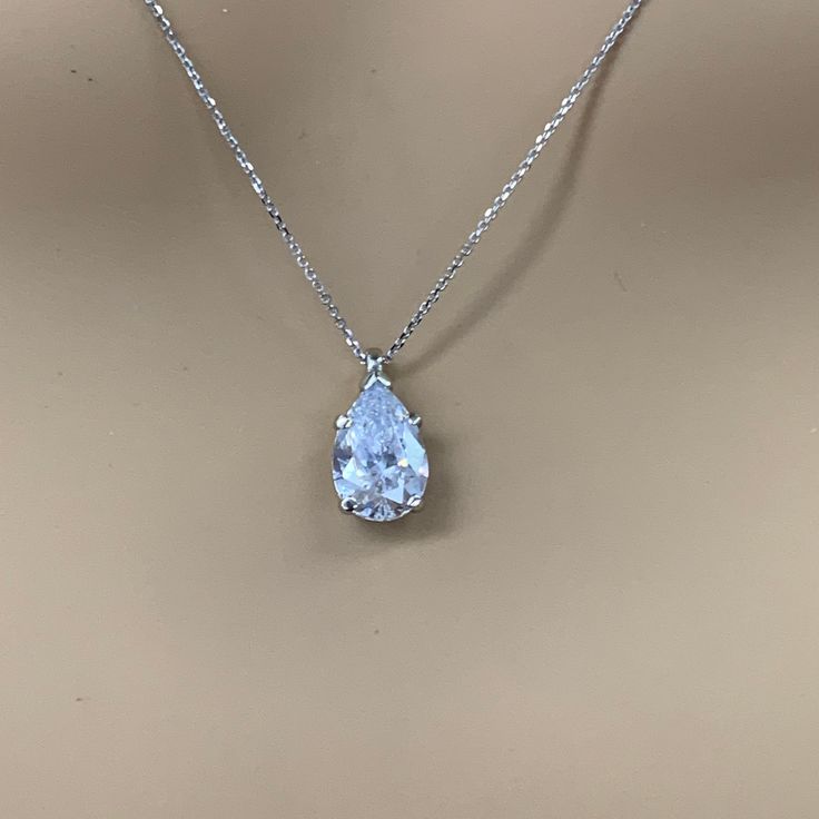 "The pendant pictured is a simulated diamond #6998 Also available with moissanite - please message us for pricing. -Approximate total carat weight: approx. 3.60ctw diamond equivalent -Center Stone Size: 12x8mm - approx. 3.60ct diamond equivalent -Center Stone Shape: pear / tear drop -Gem Type: simulated diamond -Stone Clarity: VVS1 -Stone Color: D -Moh's Scale: 8.5 hardness -Metal Type and Purity: 14k white gold -Setting: 5 prong basket head -Chain: delicate 14k gold chain / heavier option with Formal Pear-shaped Diamond Cut Drop Necklace, Pear-shaped Cubic Zirconia Diamond Necklace For Formal Occasions, Formal Pear-shaped Cubic Zirconia Diamond Necklace, Diamond White Teardrop Diamond Necklace For Formal Occasions, Formal Teardrop Diamond White Diamond Necklace, Formal Teardrop Drop Necklace With Diamond Cut, Formal Teardrop Diamond Cut Necklace, Pear-shaped Brilliant Cut Drop Necklace For Wedding, Formal Pear-shaped Solitaire Necklace