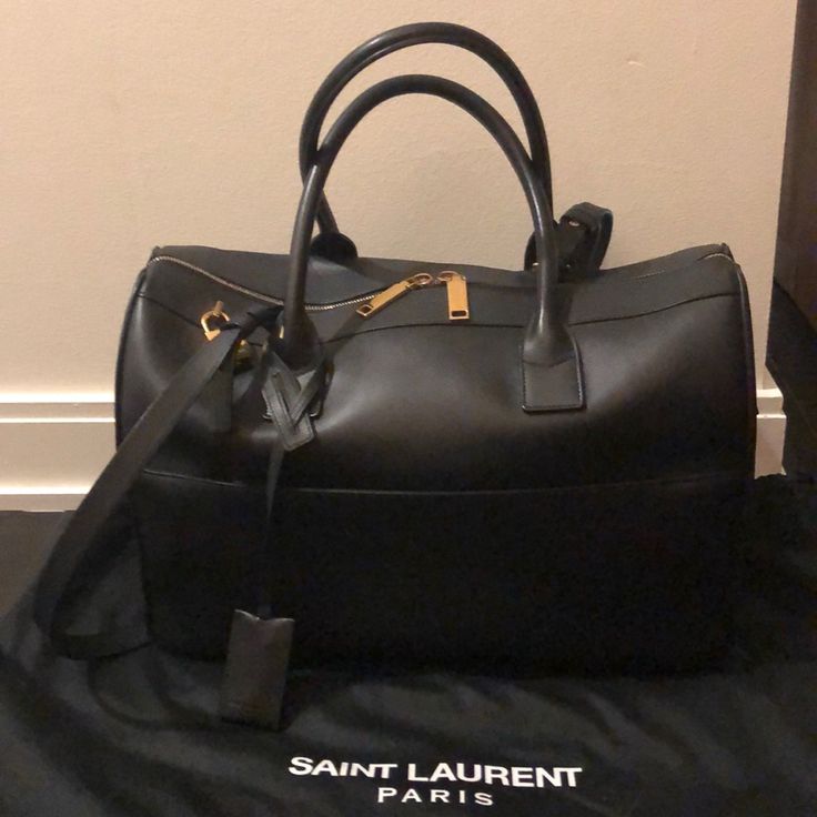 Saint Laurent Black Smooth Leather Duffle Bag. Width 15” X Height 10” X Depth 6” Saint Laurent Bags, Leather Duffle Bag, Leather Duffle, Saint Laurent Bag, Selling On Poshmark, Luxury Items, Smooth Leather, Duffle Bag, Saint Laurent