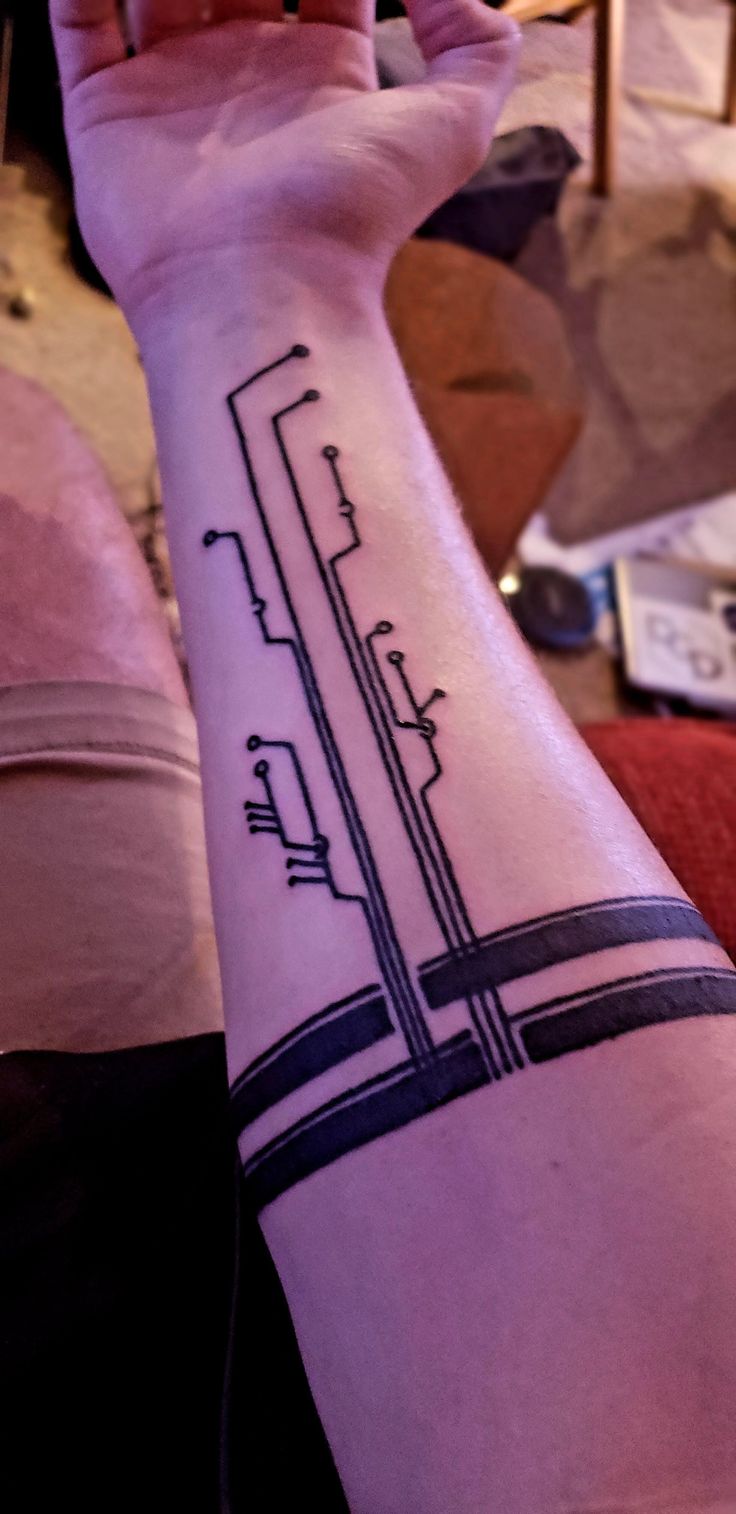 a person's arm with a tattoo on it that has an image of a train coming out of the tunnel