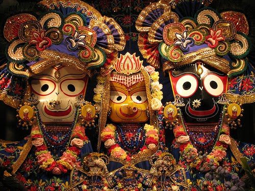 three masks on display in front of a wall